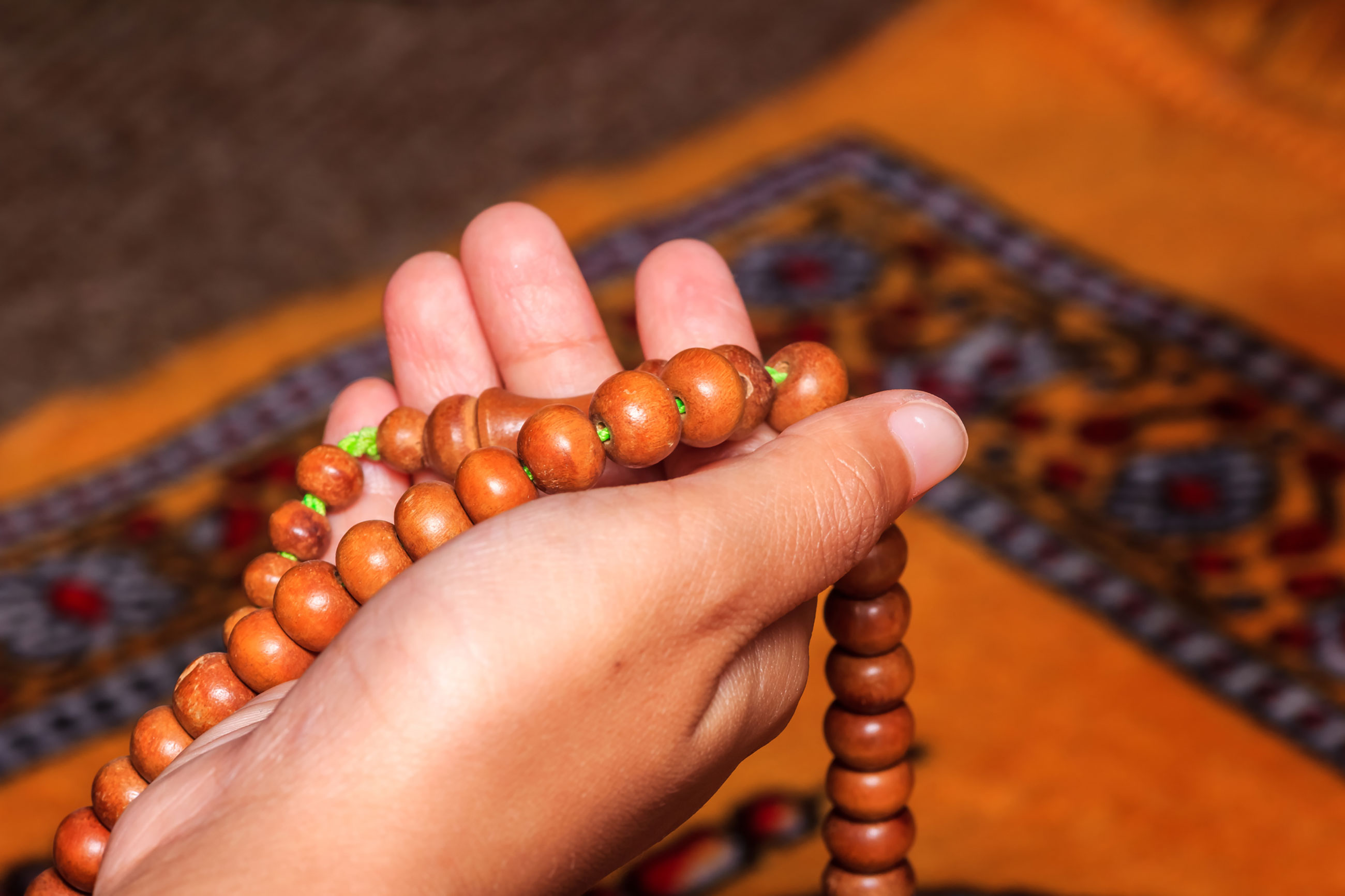 Hand holding religious beads