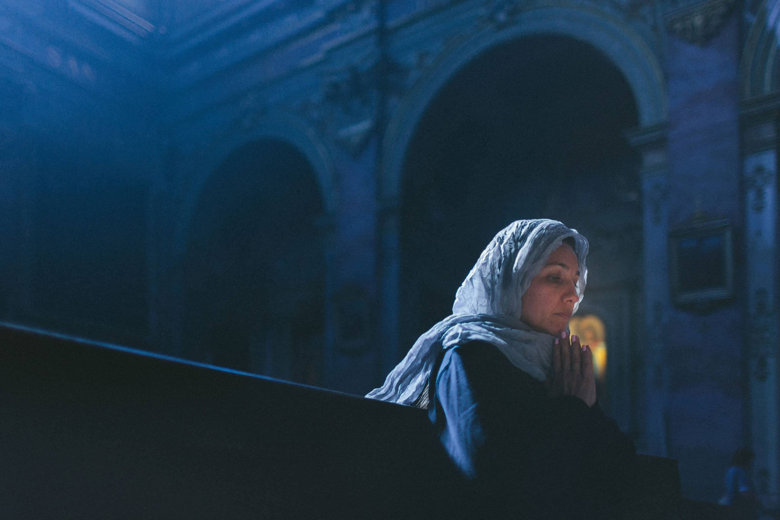 Woman with head cover alone in religious setting