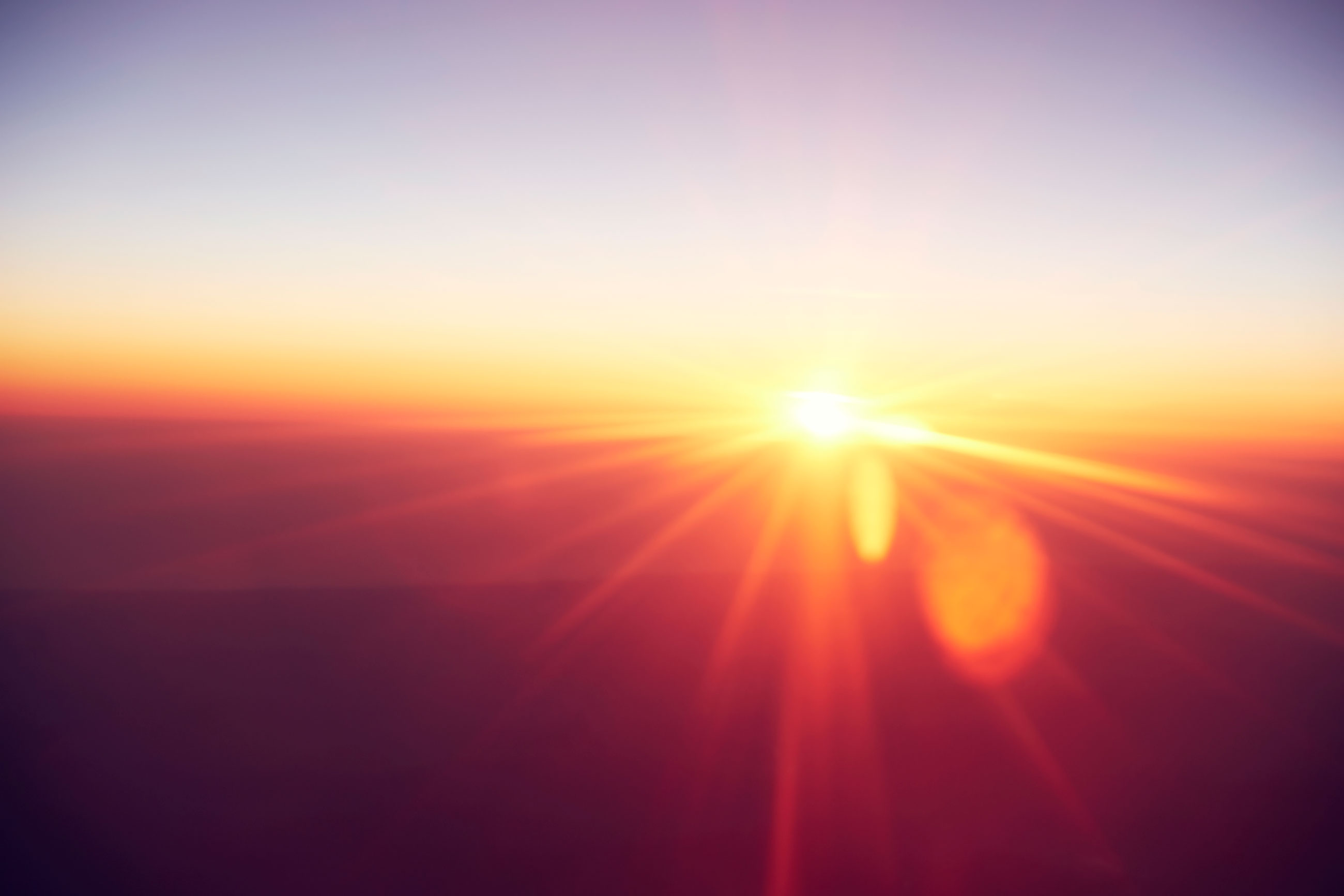 Sun breaking through above the horizon
