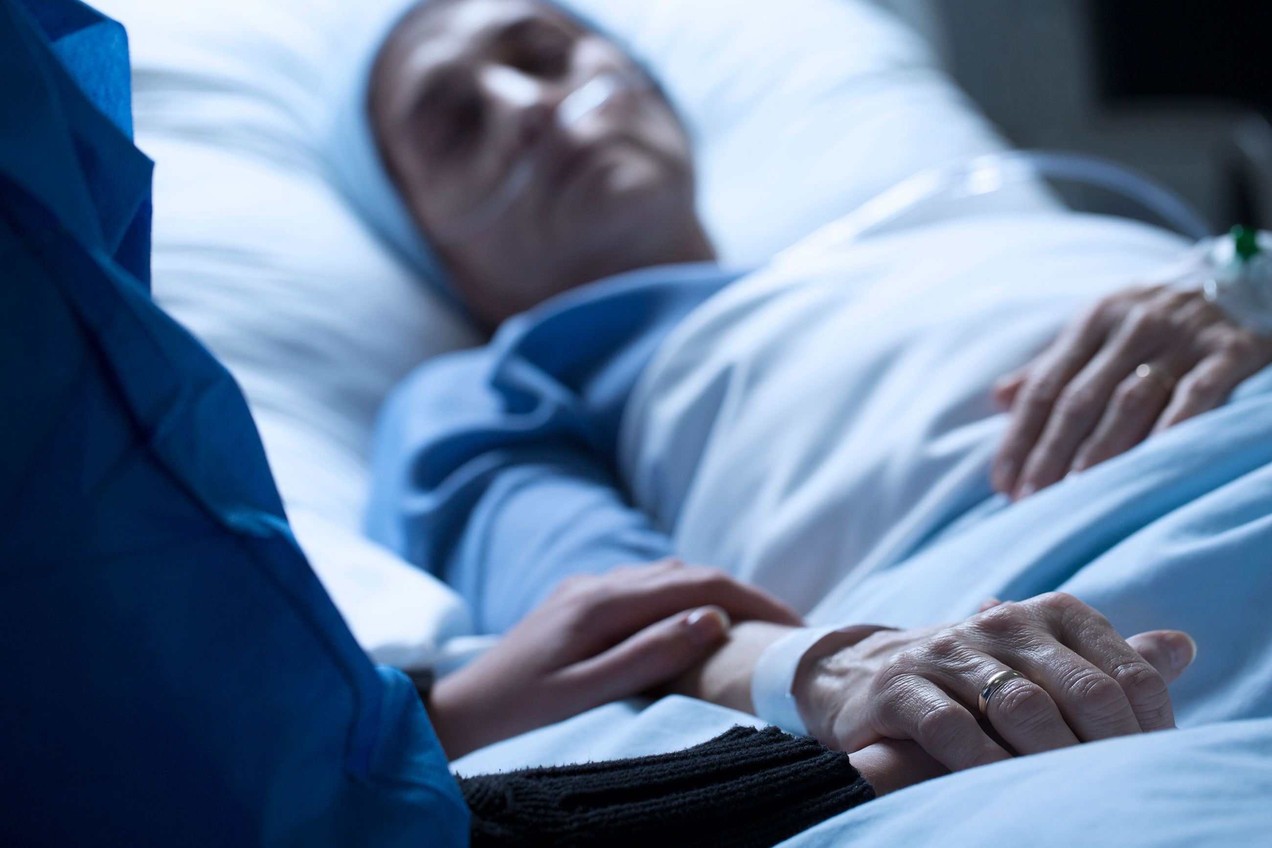 Visitor at the hospital bedside of a loved one