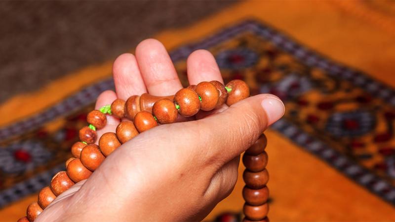 Hand holding religious beads