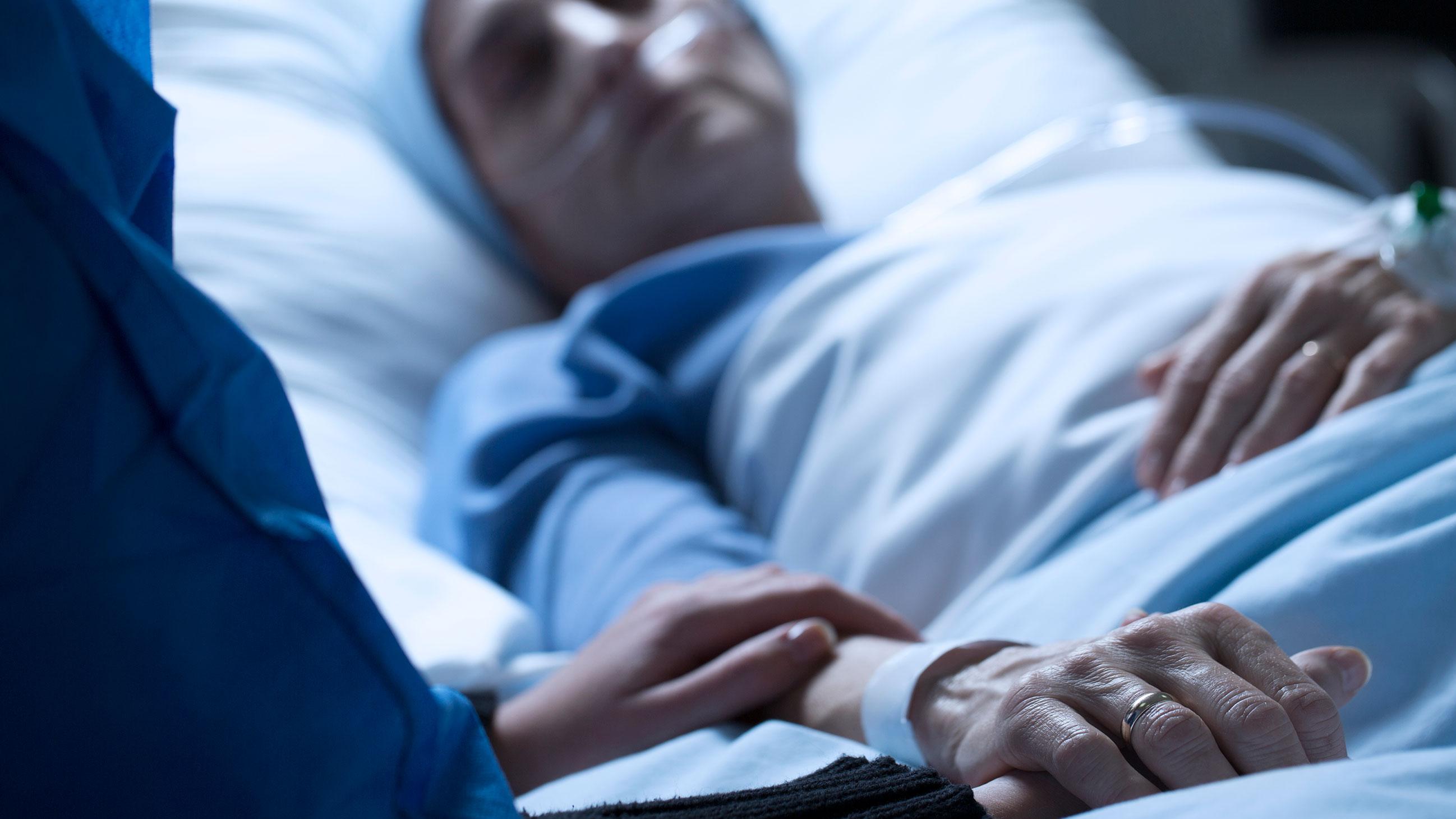 Visitor at the hospital bedside of a loved one